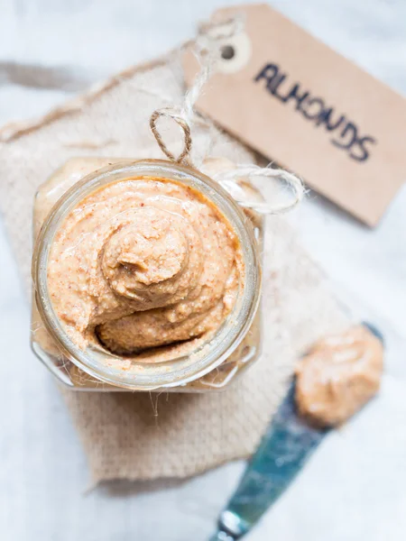 Homemade natural almond butter in a glass jar — Stock Photo, Image