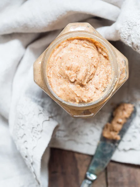 Homemade natural almond butter in a glass jar — Stock Photo, Image