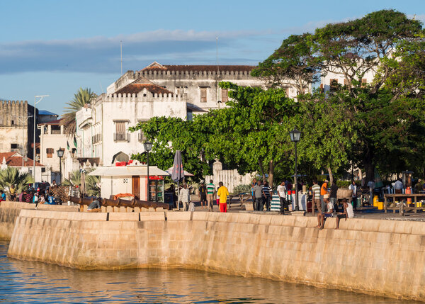 People walking on the seafront in Stone Town