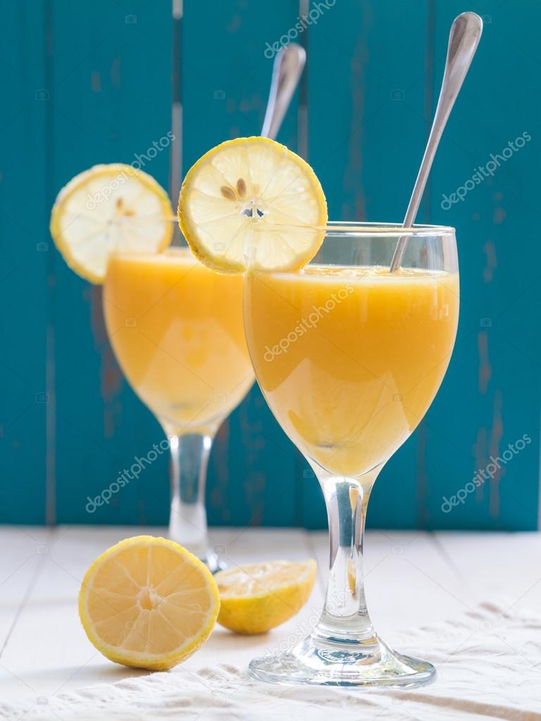 glasses of fresh yellow tropical fruit smoothie