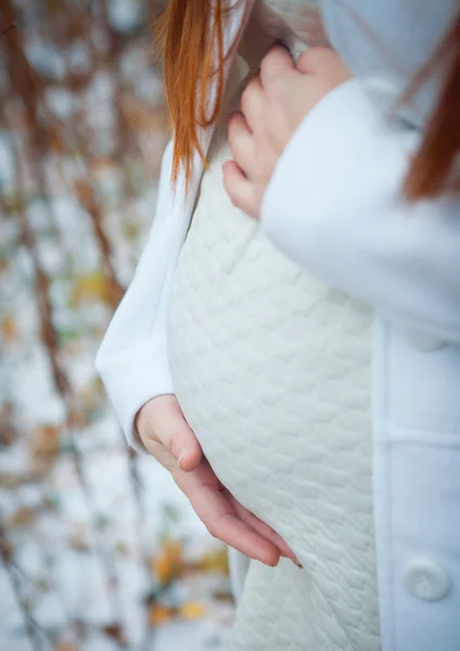 Foto de una mujer embarazada tumbada y mirando su barriga mientras la toca —  Fotos de Stock