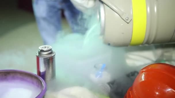 Spezialisten, die mit flüssigem Stickstoff arbeiten. Transfusion von Stickstoff in den Tank. der Dampf aus der Reaktion mit der Luft. — Stockvideo