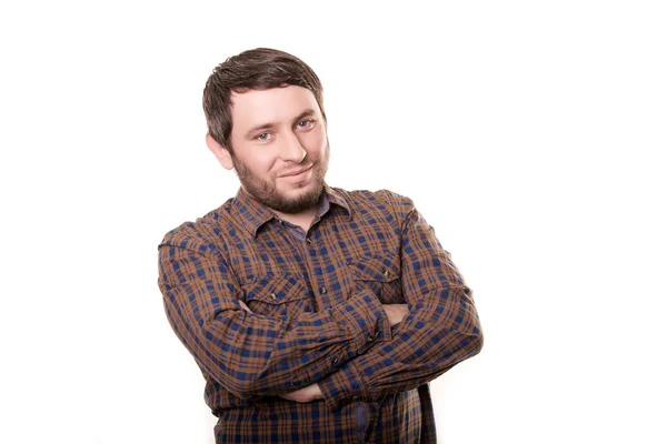 Portrait of a smiling happy handsome middle-aged man with a beard wearing a striped shirt looking at the camera with a warm friendly smile against a white studio background — Stock Photo, Image