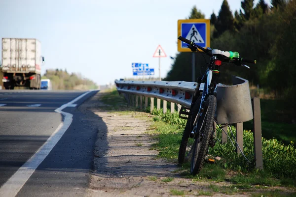 Yol kenarındaki karayolu üzerinde bisiklet ayakta — Stok fotoğraf
