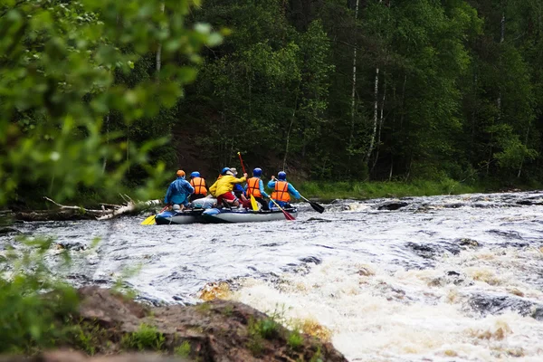 Group of athletes floats on an inflatable catamaran on the mountain river — Stock Photo, Image