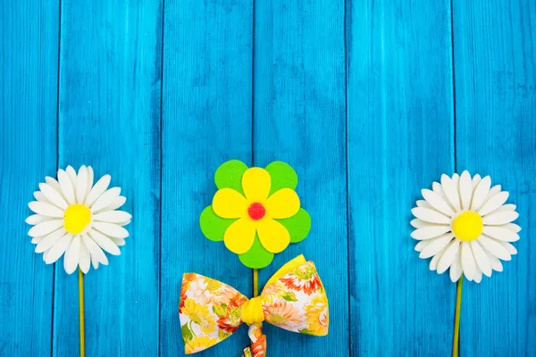 Floral composition with bow tie on blue background — Stock Photo, Image