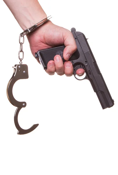 Male hand robber in handcuffs with a gun isolated on a white background — Stock Photo, Image