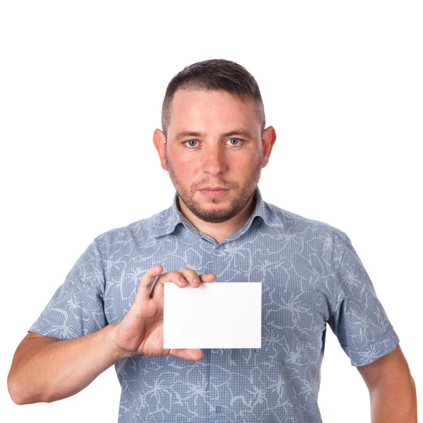 Attractive adult man with stubble in summer shirt in his hands holding a white sheet with space for advertising text on an isolated white background — Stock Photo, Image