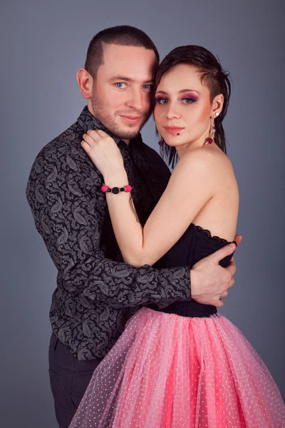 Serious business man in a black shirt with a flirty girl — Stock Photo, Image