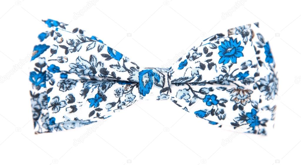 Blue bow tie with a pattern with summer flowers on an isolated white background
