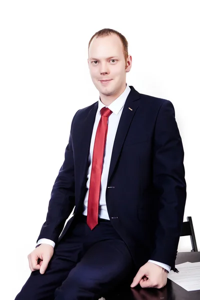 Office workers in a suit with a red tie sitting on the edge of a — Stock Photo, Image