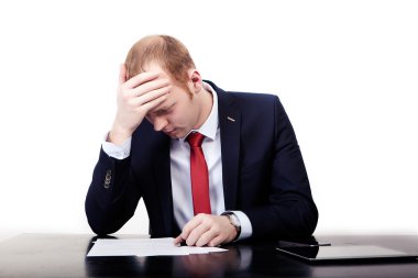 Businessman in red tie at the table took head after signing 