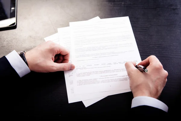 Image of human hand with pen over documents at workplace — Stock Photo, Image