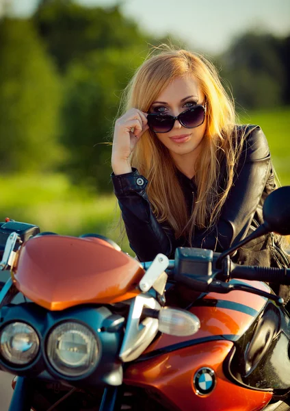 Молода сексуальна жінка сидить на червоному мотоциклі — стокове фото