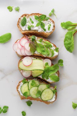 Yumuşak peynirli sandviçler, turp ve salatalık.