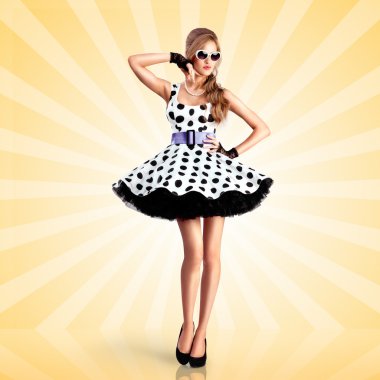 Noktalı elbise. Bir vogue pin-up kız Yaratıcı fotoğraf, bir retro polka-nokta elbise ve güneş gözlüğü giymiş, renkli soyut karikatür tarzı arka plan üzerinde poz.