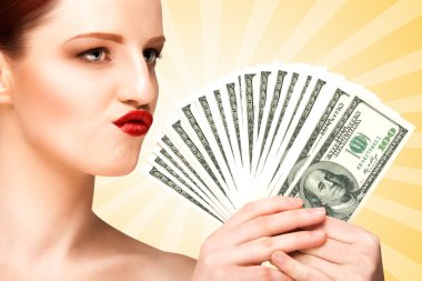Spending money. Creative portrait of a nude girl with beautiful face and body holding hand fan made of 100-dollar currency banknotes on colorful abstract cartoon style background.