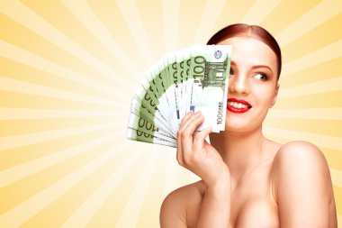 Spending money. Creative portrait of a nude girl with beautiful face and body holding hand fan made of 100-euro currency banknotes on colorful abstract cartoon style background.