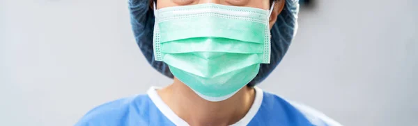 Asian female doctor wearing protection face mask against coronavirus. banner medical staff preventive background with copy space in the hospita