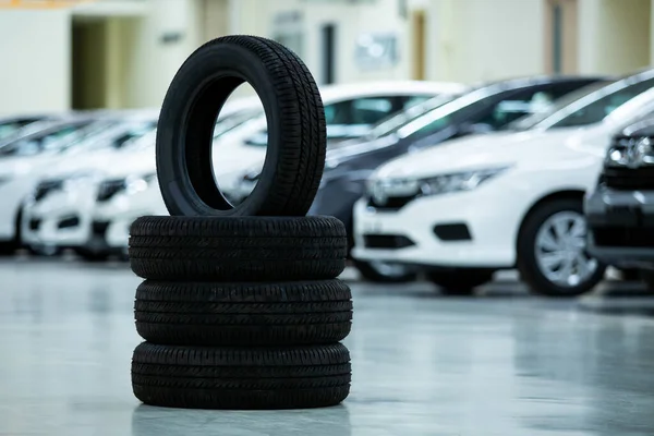 New tires that change tires in the auto repair service center, blurred background, new car tires in the stock blur for the industry in large warehouse