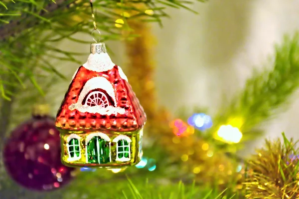 Christmas toy little house on the tree — Stock Photo, Image