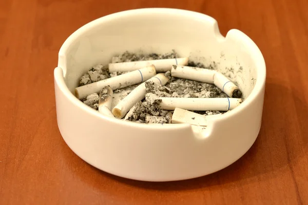 Cigarette in ashtray on table — Stock Photo, Image