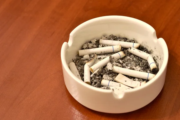 Cigarette in ashtray on table — Stock Photo, Image