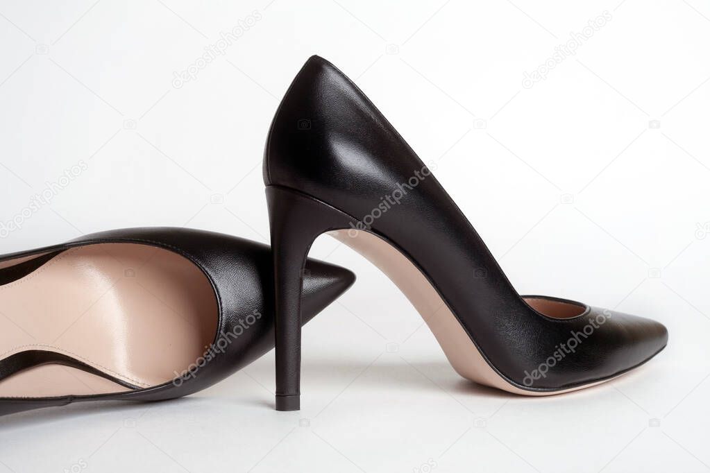 Black high heels on white background