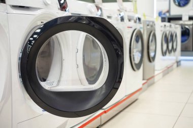 Bir ev aletleri dükkanında çamaşır makinesinin kapısını aç..