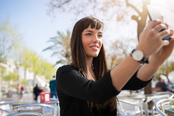 Kvinna tar sig ett foto med mobilen — Stockfoto