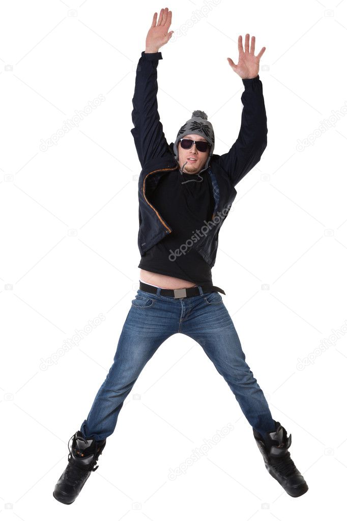 Young joyful man in winter wear jumping