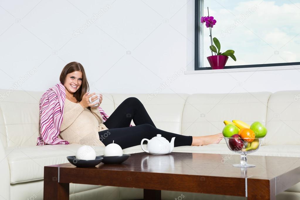 Smiling pregnant woman with mug of hot chocolate