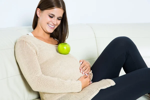 Young pregnant woman on sofa — Stock Photo, Image