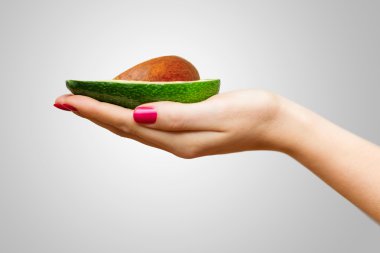 İnsan eli üzerinde avokado yarısını