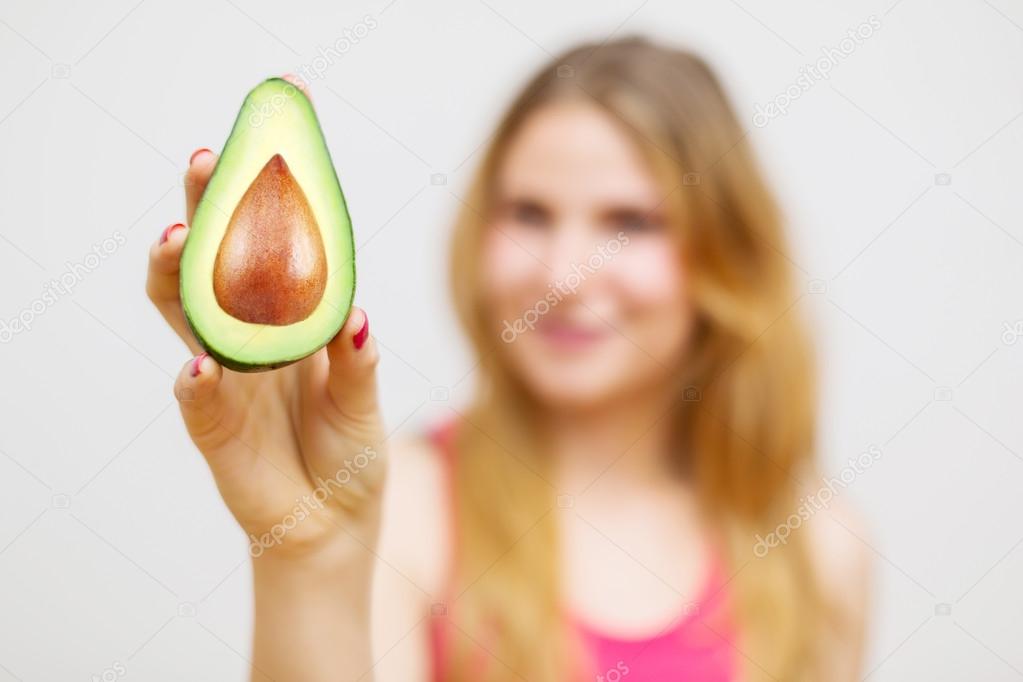 Unrecognizable woman with avocado