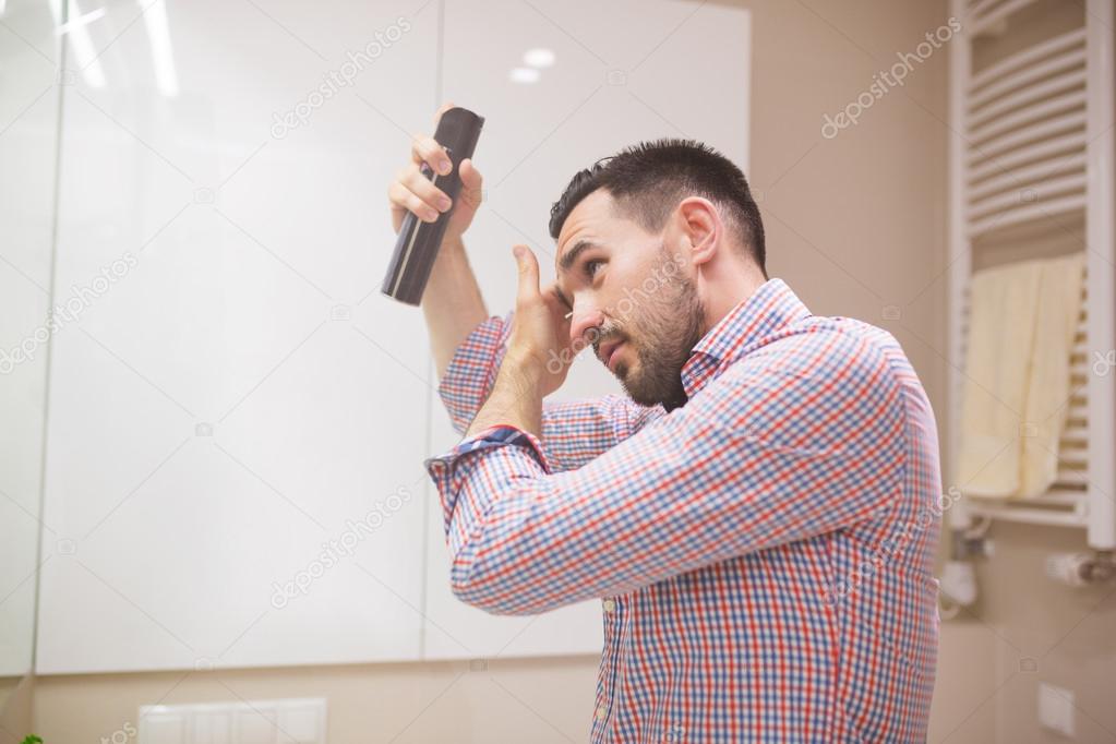 Man using hair spray