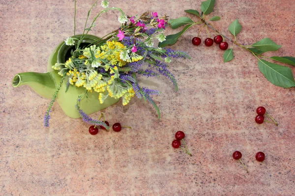 lavender flowers in a teapot on a wooden background