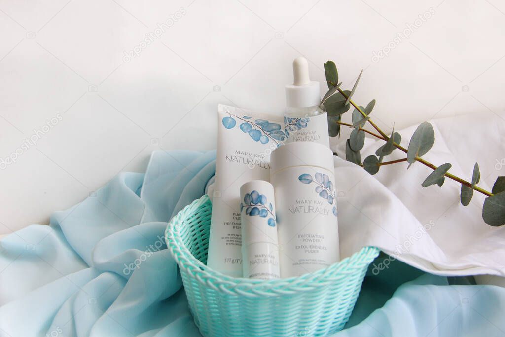 the system of creams for facial skin care from the company Mary kay on a blue fabric in a birch basket with a white towel are creams 15.03.2021