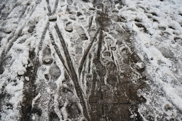 foot tracks in snow on street