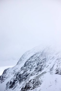 Tepesinde kar olan harika dağ manzarası. 