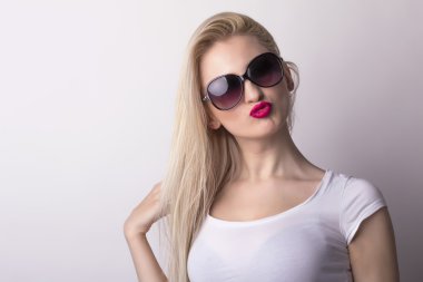 Attractive blonde woman sending a kiss