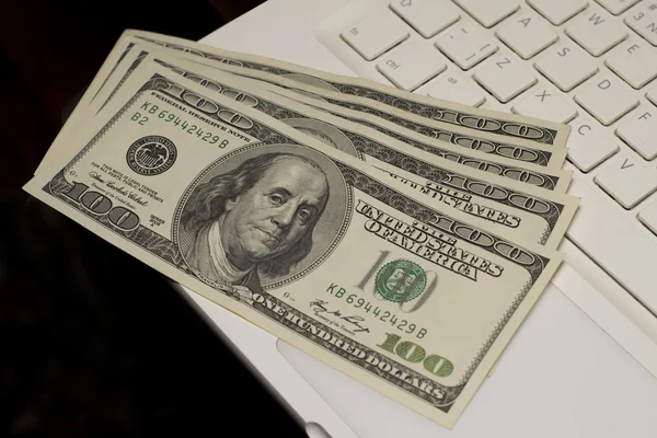 Dollars on a keyboard of a laptop — Stock Photo, Image