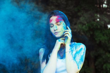 Renkli toz ile oynarken şehvetli esmer kadın