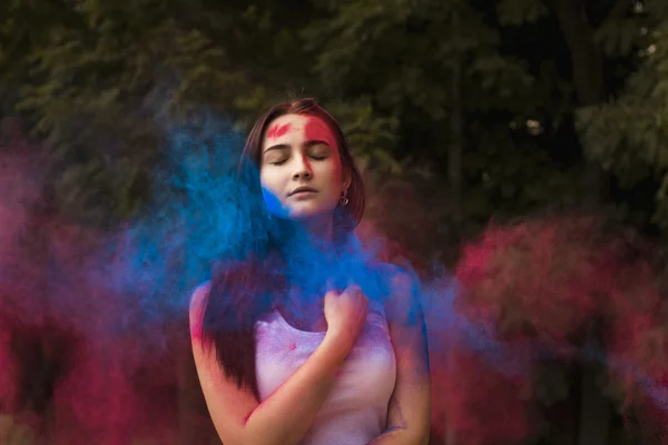 Sensual woman with colored powder exploding around her — Stock Photo, Image