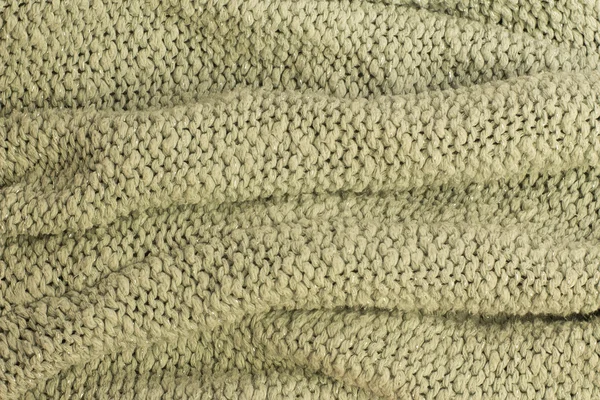 Фрагмент светло-зеленого вязального шерстяного свитера — стоковое фото