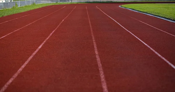 Empty red running track with markup outdoor