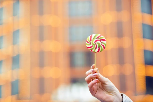 Woman Holding Caramel Candy Street Blurred Bokeh Background Space Text — Stock Photo, Image