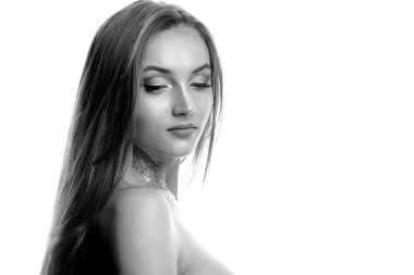 Yakından çekilen güzel bir fotoğraf, boynundaki parıltı ve profesyonel makyajla poz veren harika bir sarışın model. Siyah ve beyaz resim, metin için boşluk