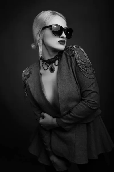 黒と白のスタジオポートレートのファッショナブルなブロンド女性身に着けているサングラスとジャケット上の裸の体 — ストック写真