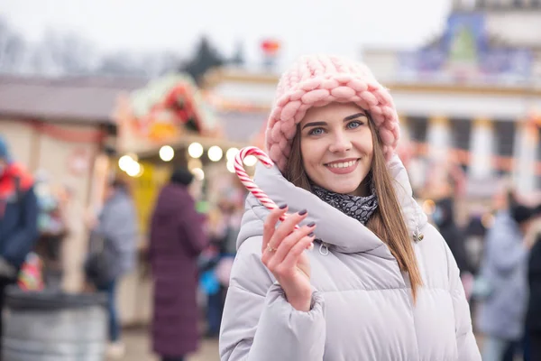 Joyful Young Woman Wears Pink Hat Grey Coat Holding Candy — Stock Photo, Image
